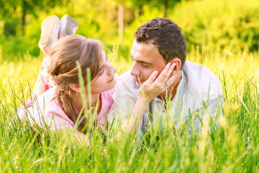 Close-up of a young couple in love on grass
