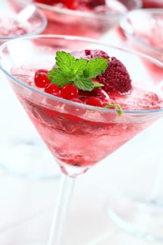 Delicious light summer cocktail with rosa champagne and black currant sorbet