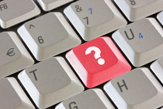 Computer keyboard with red question key - business concept