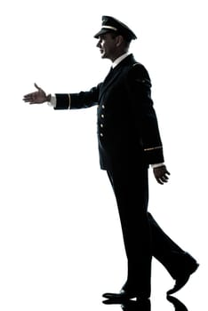 one caucasian man in airline pilot uniform walking handshake silhouette in studio isolated on white background