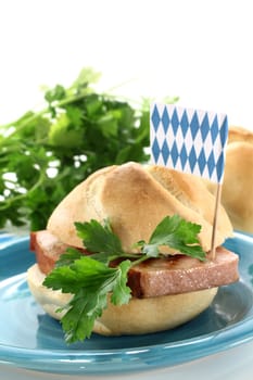 a roll with meatloaf and parsley