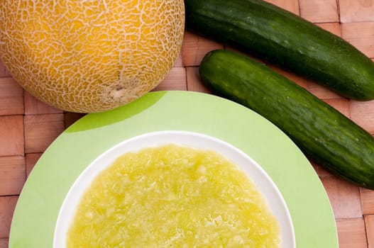 Cold soup with melon and cucumber in a plate