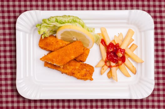 Three fish fingers with lettuce and lemon and french fries with ketchup