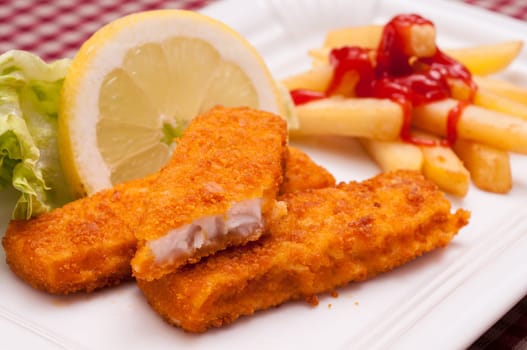 Fish fingers with lemon and green salad and French fries