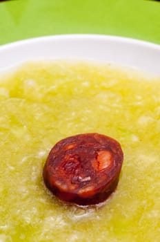 Spicy pork sausage chorizo in cold melon soup