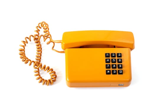 Old orange telephone isolated on white background