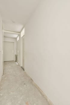 an empty room with white walls and no one person standing in the doorway, or door to the other room