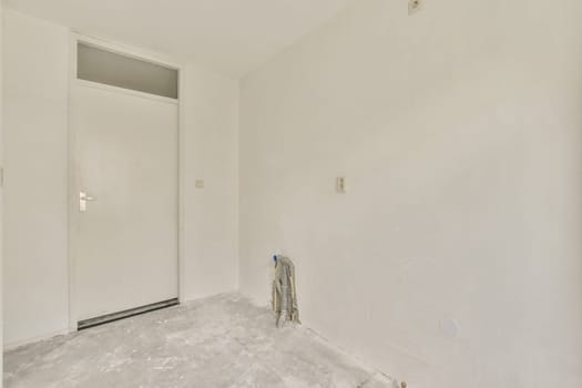 an unfinished room with white paint on the walls and door to the other rooms in the room is being renovated