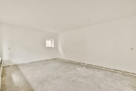 an empty room with white walls and no one wall in the room is visible on the right side of the photo