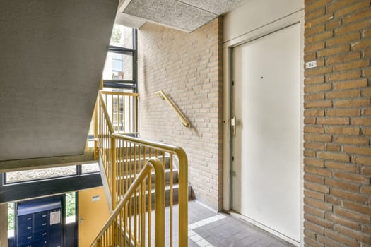 the outside of a building with stairs leading up to an open door that leads to a small balcony and patio