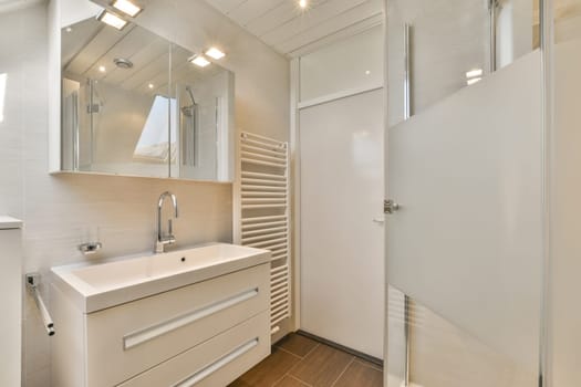 a bathroom with a sink and mirror on the wall next to it is an open door that leads to a walk - in shower