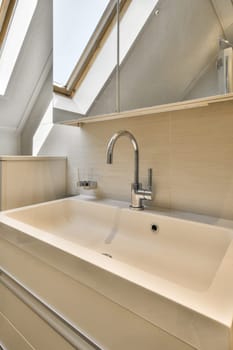 a bathroom with a skylight above it and a sink in the fore - image is taken from an angle
