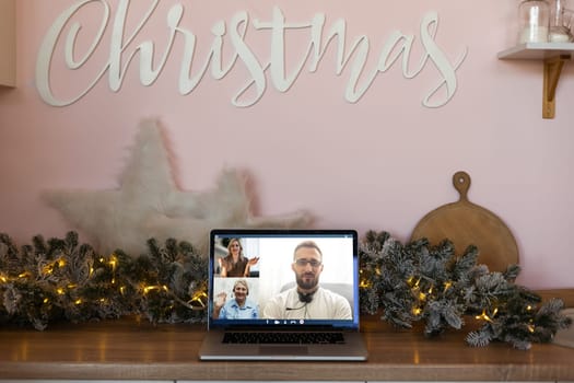 Family video call by remote chat laptop computer screen on Christmas holiday background. Xmas online virtual family party celebration, Happy New Year videocall