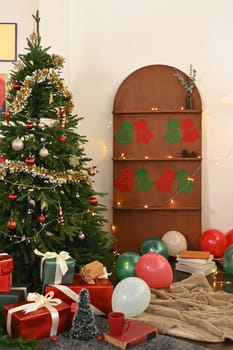 A Beautiful living room decorated with Christmas tree and present boxes all around the room.