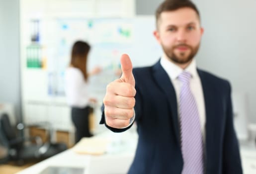 Focus on male hand performing friendly gesture towards presumptive colleague or boss in order to greet. Smart people discussing important business strategy. Company meeting concept. Blurred background