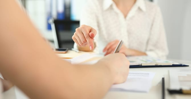 Focus on gorgeous female explaining every complicated detail of important business contract that can highly increase corporation profit. Company meeting concept. Blurred background