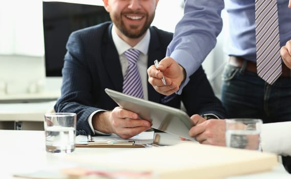 Close-up of smart business people smiling and discussing important contract that determine future of many workers and whole corporation. Company meeting concept