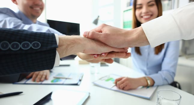 Focus on folded hands on each other. Businessmen discussing stipulation of profitable contract and closing bargain. Business meeting concept. Blurred background