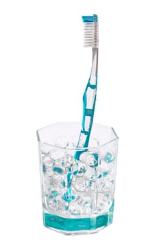 Turquoise toothbrush in a glass jar