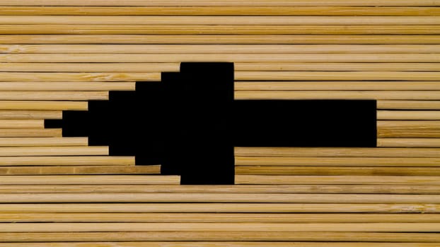 Wooden sticks making the silhouette of an arrow