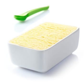 Ceramic tub filled with textured delicious frozen vanilla icecream ready to be served for dessert at a summertime meal