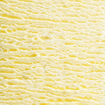 Macro abstract background of the surface texture of scoop of fresh creamy frozen vanilla icecream in square format. For ice-cream concept look at my portfolio