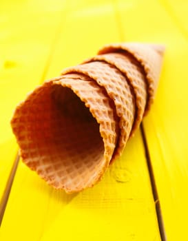 Close up shot of four Ice cream cones on yellow table