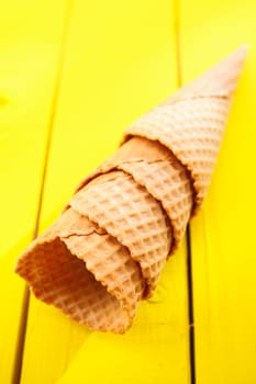 Close up shot of four Ice cream cones on yellow table