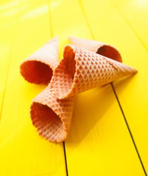 Close up shot of four Ice cream cones on yellow table