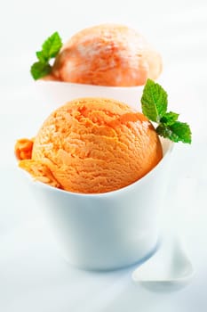 Orange scoops of icecream on white background. For ice-cream concept look at my portfolio