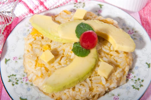 Rice pudding with avocado on a pink background