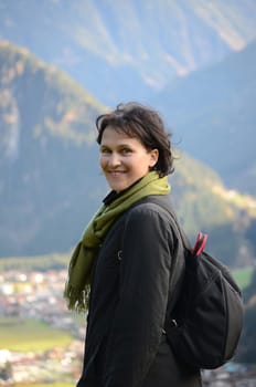 Attractive woman on autumn vacation in the mountains (Alps)