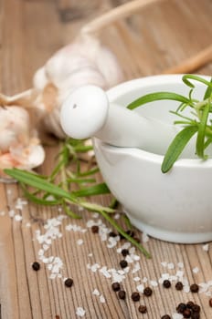 Mortar and Pestle With Ingredients - Rosemary, Salt, Pepper and Garlic