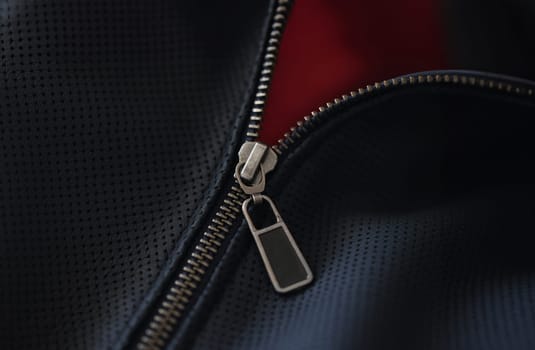 Closeup of steel zipper on leather jacket. Zipper replacement services concept