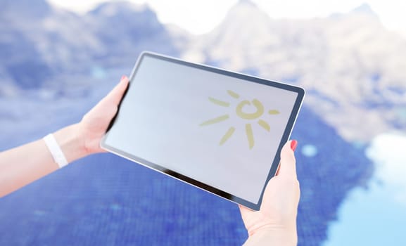 Female hands holding digital tablet with drawn sun over pool closeup. Online weather forecast concept