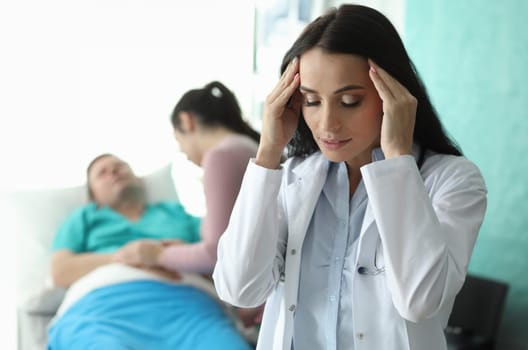 Doctor holds his head near sick man lying on bed. Resuscitation and intensive care unit. Care and correction condition incurable patients. Treatment and prevention ailments. Early diagnosis for cure