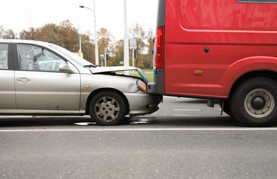 On road car crashed into trunk truck an accident. City street, Warning triangle. Assess situation and degree complexity accident. Deprivation or fine. Compliance with traffic regulations
