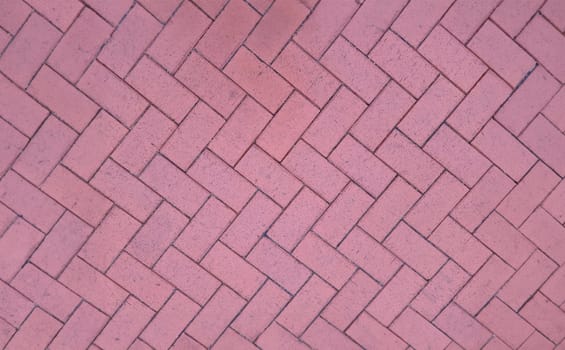 Paving slabs laid out in shape of herringbone on city street background. Improvement of streets concept