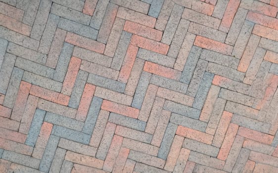 Brown paving slabs laid out in herringbone shape background. Urban architecture concept
