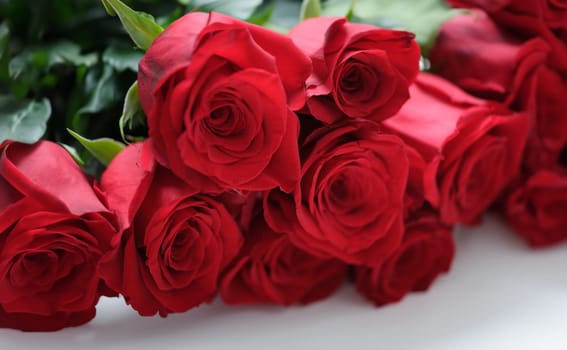 Closeup of large bouquet of red roses background. Flower delivery concept
