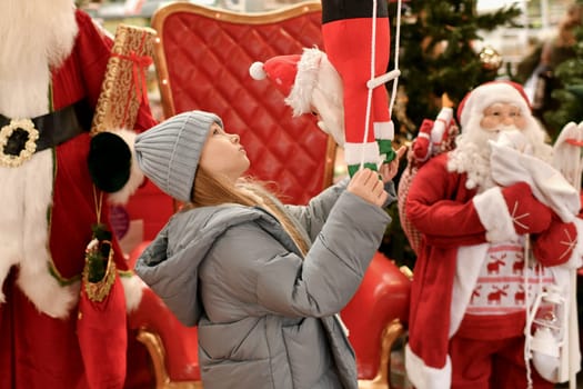 A child is surrounded by Santa Clauses in a shop