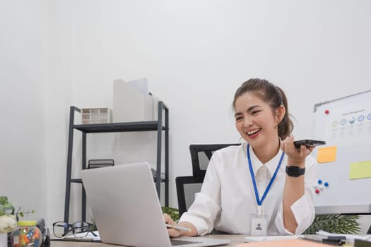 Young businesswoman uses the phone to talk with customers in business planning, business management..