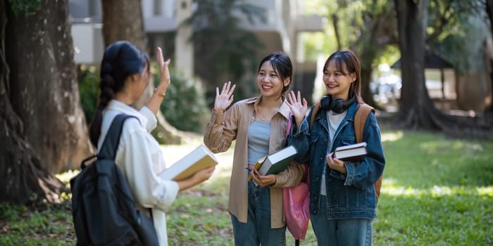 Happy young student chat with each other after class. Guy and girls wear casual clothes to study. Lifestyle College and University life concept, sincere emotions.