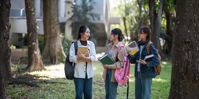 Happy young student chat with each other after class. Guy and girls wear casual clothes to study. Lifestyle College and University life concept, sincere emotions.