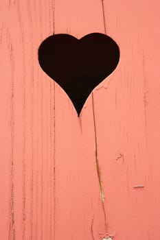 heart cut out in a wooden wooden wall