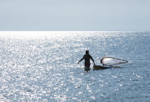Surfer lands on the beach and pulls surfboard