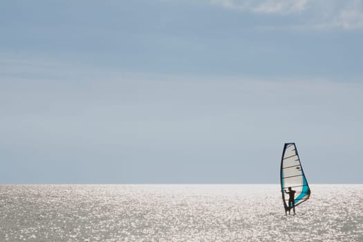 Surfer standing on his board in low wind