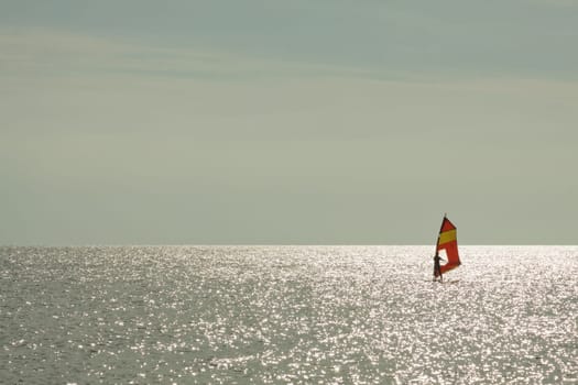Surfers backlit on the Baltic Sea
