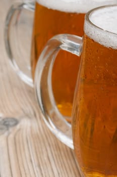 Close-up of Glasses of Beer on Old Wooden Table
