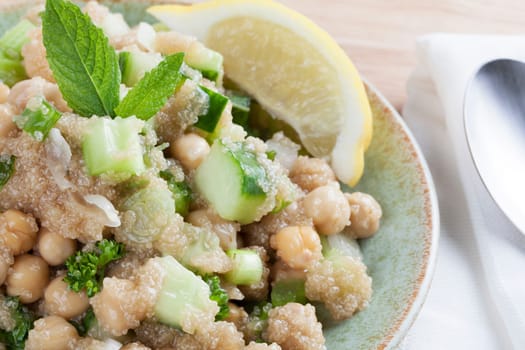 Cooked amaranth seeds with cucumber chickpeas and mint in a tabouli style vegan salad.